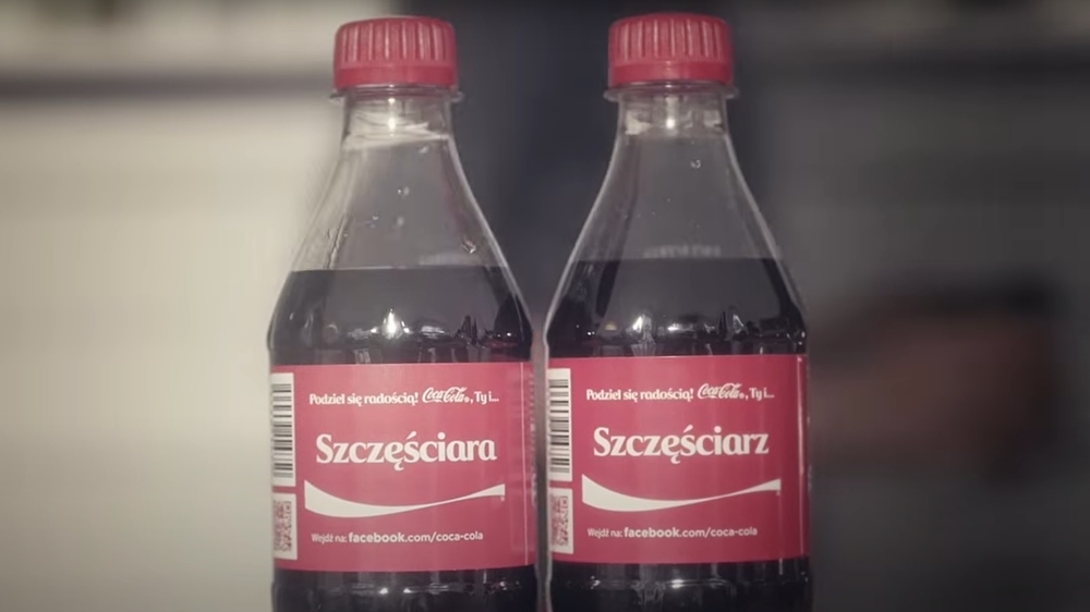 dwie butelki coca coli z napisami